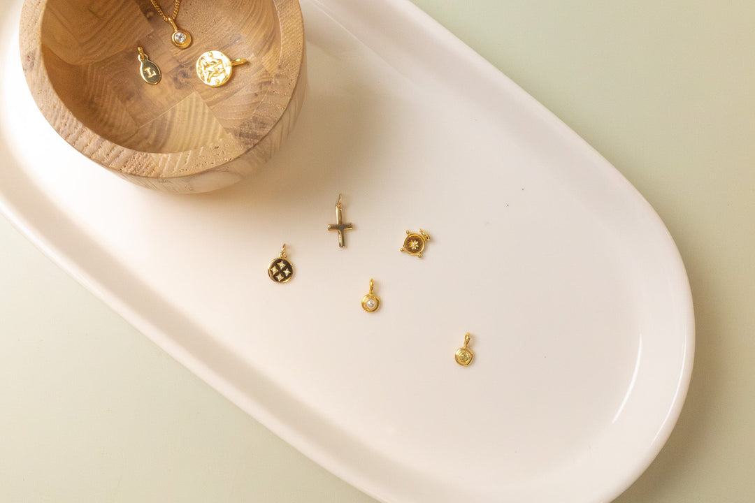 Feature image of charms and necklaces on a tray, showing you how you can personalise your jewellery.