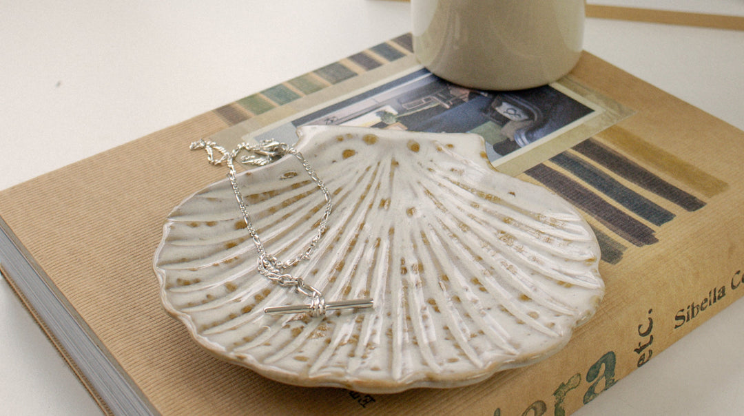 Feature image of charms and necklaces on a tray, showing you how you can personalise your jewellery.