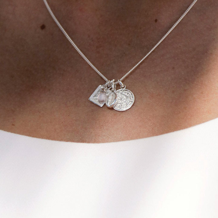 TINY TRUE NORTH CHARM