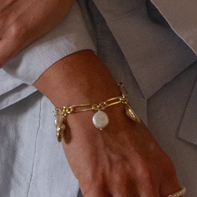 THE WORLD IS YOUR OYSTER PEARL CHARM BRACELET