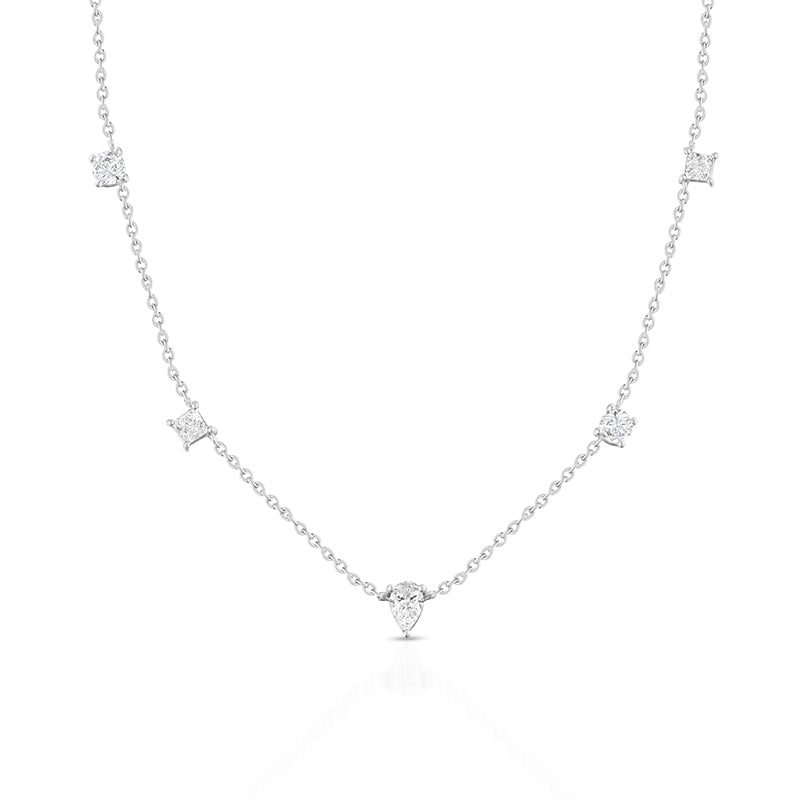 A delicate silver chain necklace featuring multiple small star-shaped clusters of clear stones and a pear-cut center stone, displayed on a clean white background with a soft reflection.