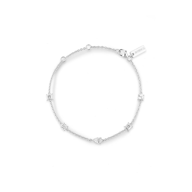 A delicate silver chain bracelet with small star and rectangular bezel-set clear stones, displayed on a clean white background. A small brand tag is attached near the clasp.