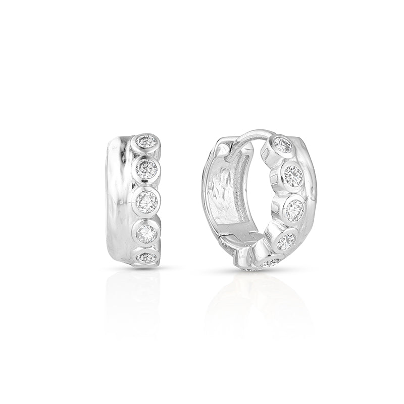 A pair of silver huggie hoop earrings adorned with round-cut clear gemstones, shown from both the front and side angles on a white background.