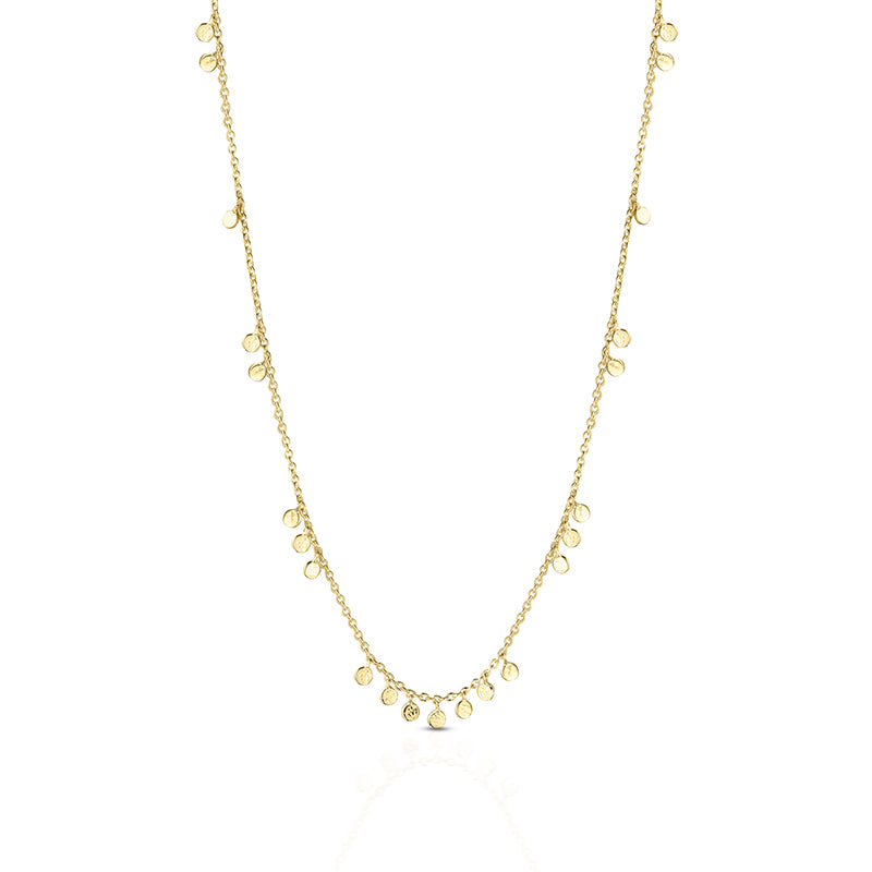 A delicate gold chain necklace featuring multiple small, flat circular disc charms in varying sizes, displayed against a clean white background.
