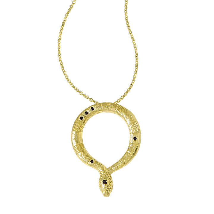 A gold snake pendant necklace with a textured coiled body, small black gemstone eyes, and a matching chain on a plain white background.
